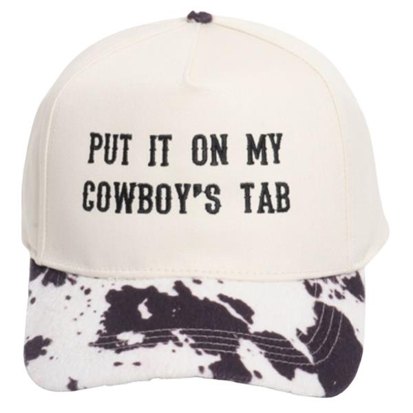 Put It On My Cowboy`s Tab Cow Print Brim Cap